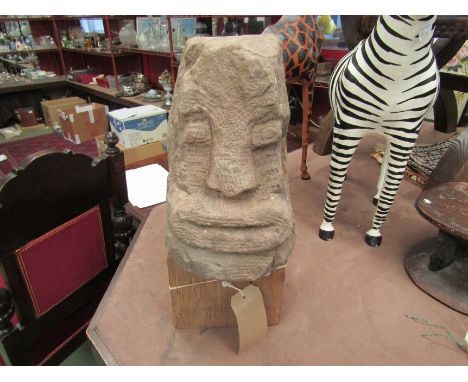 A stone carved head reputedly Welsh Celtic from Buith Wells, on oak plinth base, 48cm tall including base 