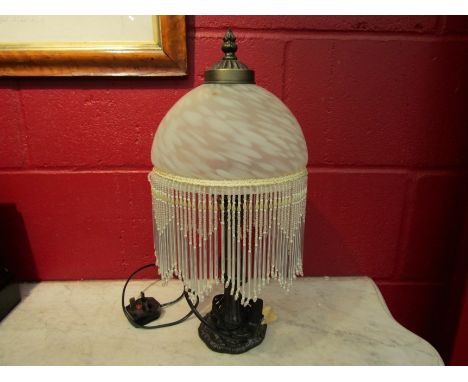A bedside lamp with glass tasselled bead shade 