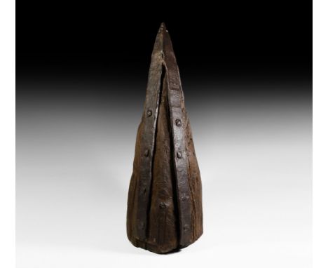 14th-15th century AD. A large and heavy tip of a battering ram formed from a mature tree trunk, trimmed to a point and fitted