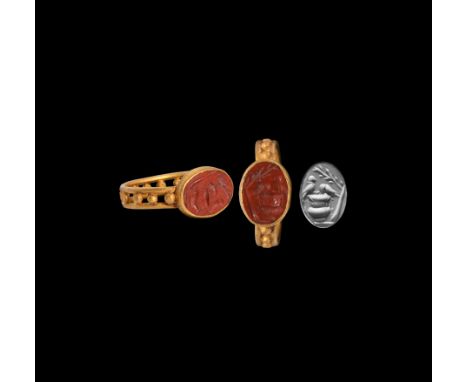 3rd-4th century AD. A gold ring with openwork hoop formed of two gold bands with granules, discoid oval bezel set with red ja