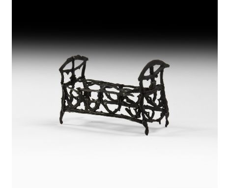 15th-16th century AD. A delicately formed openwork pewter rocking cradle, with pointed 'Gothic' arch details to sides and end