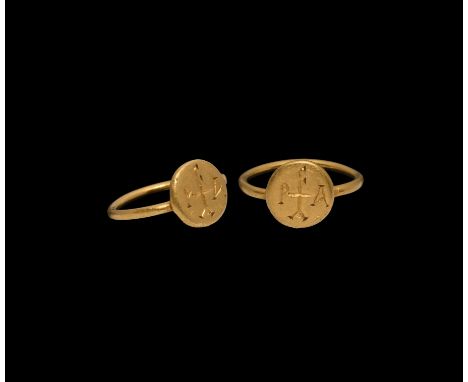 6th-7th century AD. A gold ring with round-section hoop and discoid bezel with incuse cross monogram. Cf. Chadour, A.B., Ring