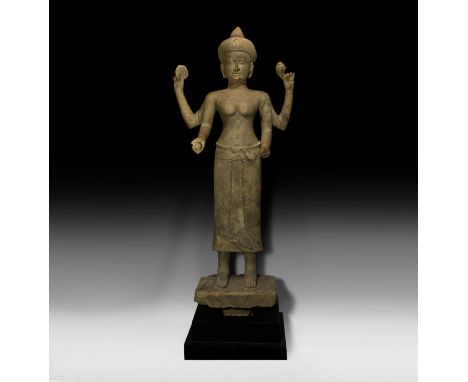 9th-11th century AD. A substantial sandstone carved statue of Lakshmi wearing a sampot with flounced hem and sash tied at the