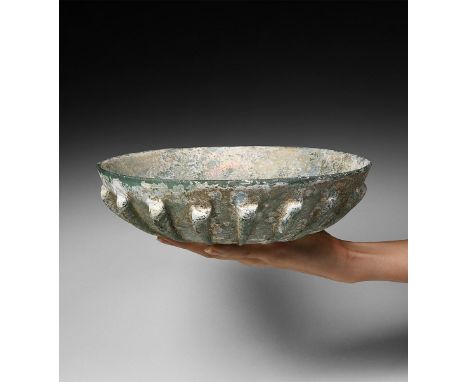 1st century BC-1st century AD. A pale green glass bowl with series of twenty tapering, raised ribs formed at regular interval