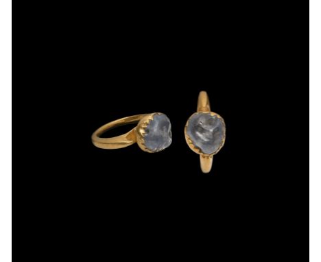 2nd-3rd century AD. A gold finger ring with scooped recess to the shoulders, granule finial, tulip-shaped cell enclosing an i