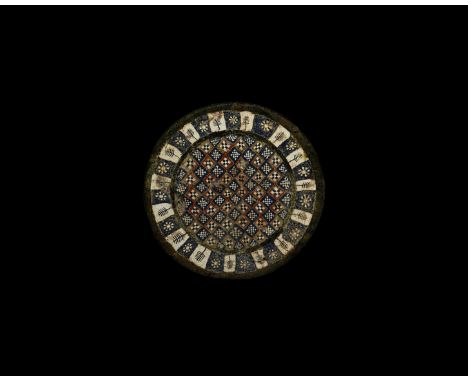 2nd century AD. A bronze disc mount with inset millefiori glass panels, central disc with alternating chequer patterns, outer