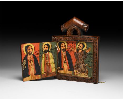 Late 17th century AD. A small wooden folding polyptych with carved frame and suspension block, painted scenes including nimba
