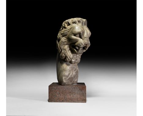 1st-2nd century AD. A marble fountain support depicting the head of a lion, the narrow face carved in high-relief with full, 