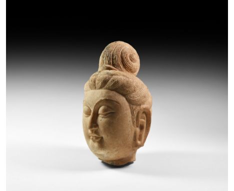 Sui Dynasty, 581-618 AD. A marble head of a bodhisattva with serene face, softly rounded cheeks, eyes downcast beneath arched