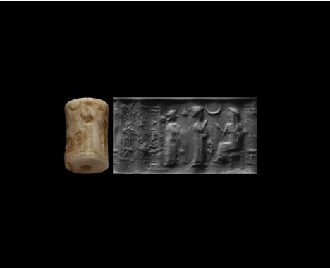 2nd millennium BC. A white jasper cylinder seal with frieze of figures and cuneiform inscription; accompanied by a museum-qua