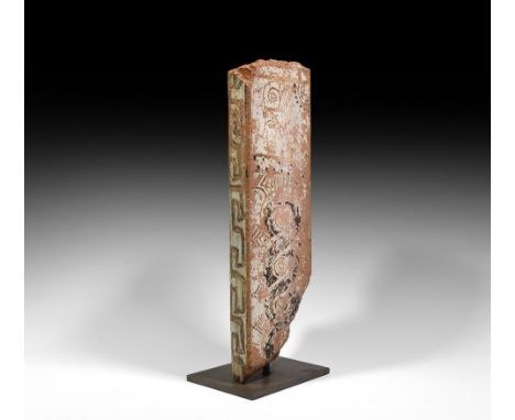 Mid 6th-mid 5th century BC. A carved ceramic fragment with white slip and black pigment field to the lateral flange; white ve