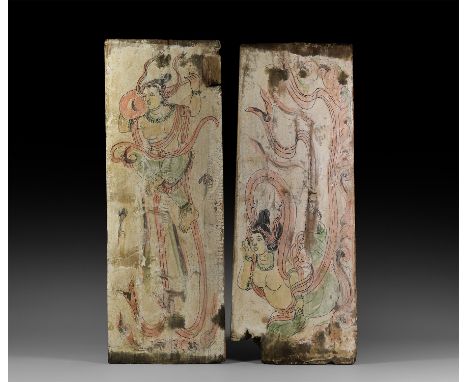 17th century AD or later. A pair of thin painted wooden panels comprising: a panel with a heavenly musician playing a stringe