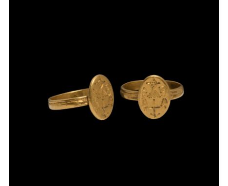 6th-7th century AD. A gold finger ring with ellipsoid plaque, intaglio facing nimbate bust of Christ flanked by two smaller b