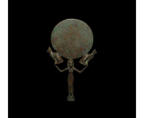 Middle Kingdom, 2040-1750 BC or later. A bronze cosmetic mirror comprising a bifacial polished disc supported by a standing f