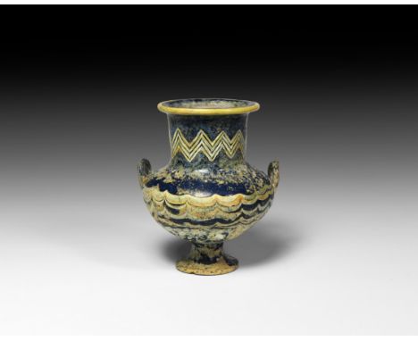 New Kingdom, 18th Dynasty, 14th century BC. A dark blue glass squat krateriskos vessel with bulbous body, pedestal foot, broa