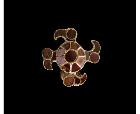 6th century AD. A silver plate brooch with domed body and four radiating profile bird-heads; the plate dished to the reverse,
