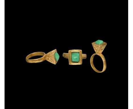 6th-8th century AD. A gold finger ring with parallel outer bands of punched pellets and median band of billets with ring and 