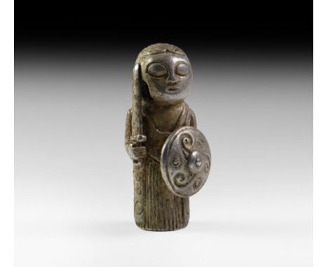 9th-10th century AD. A substantial silver figure of a maiden warrior modelled in the round, hollow to receive the end of a sh