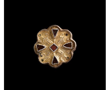 5th-6th century AD. A silver-gilt plate brooch mounted on an iron carrier plate with pin-lugs and catch to the reverse; the o