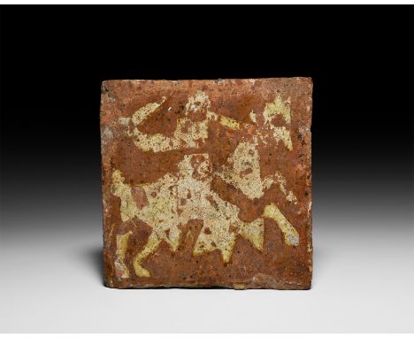 Late 13th-14th century AD. A glazed ceramic tile depicting an advancing knight on horseback, holding a sword in his raised ri