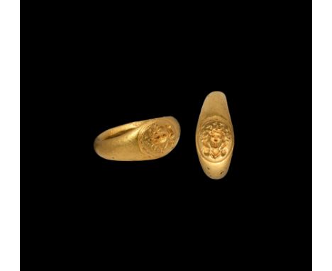 3rd-4th century AD. A gold finger ring with raised boss to the bezel with intaglio bust of Sol (Greek Helios) wearing a radia