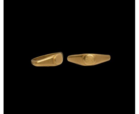 1st-2nd century AD. A gold ring with D-section shank, broad keeled shoulders and chamfered plaque. 5.21 grams, 22.40mm overal