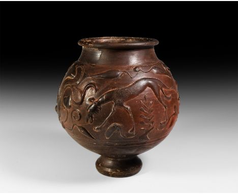 Early 2nd century AD. A large Samian ware beaker with moulded relief decoration in the Barbotine technique with a globular bo