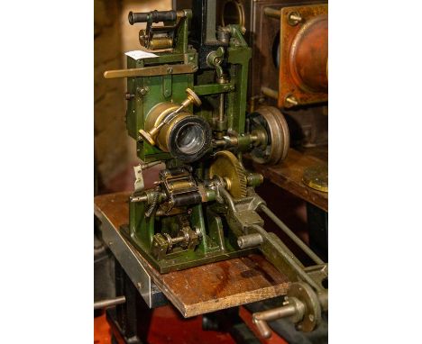 A Gaumont Chrono series CM 35mm movie projector mechanism with spool arms. Rear shutter, pulley driven. Made by Gaumont Paris