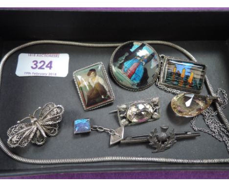 A small selection of white metal and silver jewellery including butterfly wing brooches, citrine pendant, thistle bar brooch,