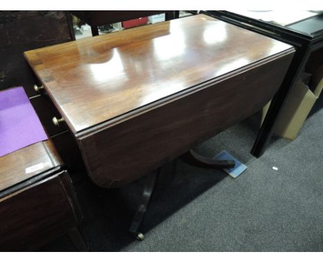 A 19th Century mahogany Regency design sofa table having drop lead top with frieze and dummy drawers on pedestal and quadrupl