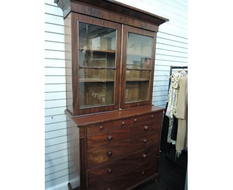 A Victorian mahogany full height bookcase having cornice and glass doors on 3 frieze, 2 short and 3 long cockbeaded drawers o