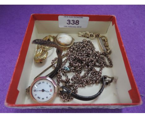 A small selection of yellow metal jewellery including conche shell cameo brooch, muff chain and 9ct rose gold wrist watch 