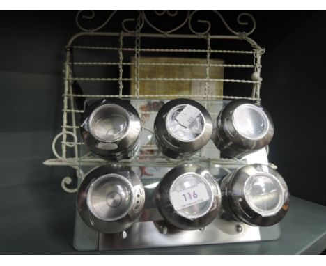 A selection of modern kitchen items including spice rack and cookery book stand