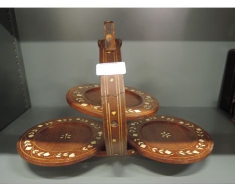 A vintage treen fold away cake display stand