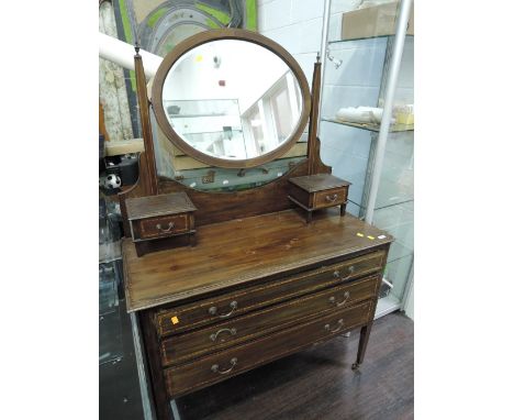 An Edwardian mahogany dressing table having chequer line inlay decoration, with oval mirror and tapered legs