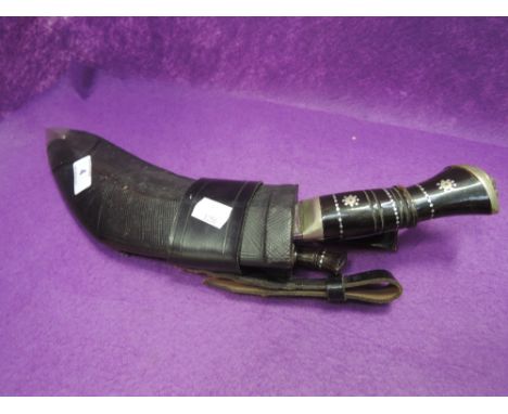 A Nepalese kukri with two small knives in scabbard 