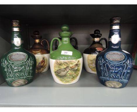 Six empty ceramic Whisky decanters