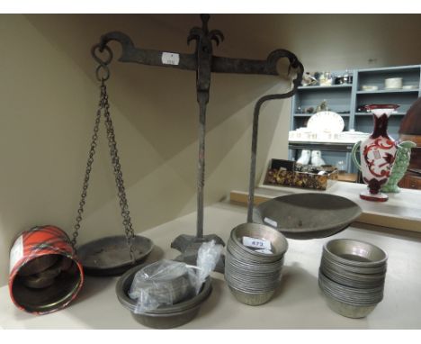 A set of cast balance scales and small individual pie or cake tins