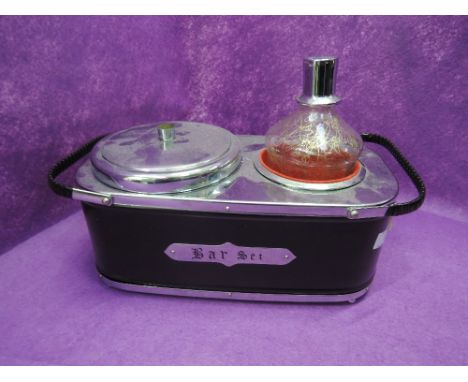 A vintage musical bar set with glass decanter and ice bucket