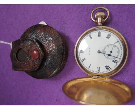 A gold plated full hunter pocket watch by Elgin having Roman numeral dial with subsidiary seconds in a plain plated case, wit
