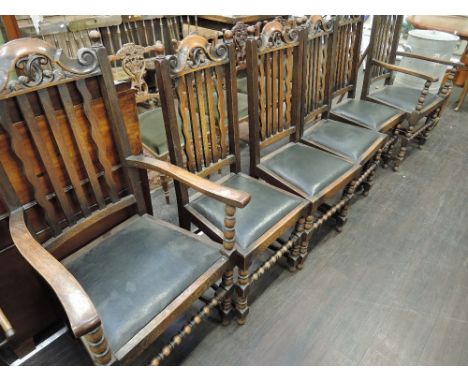 A set of six ( 4 plus 2) early 20th Century straight and wave rail back dining chairs having bobbin turned legs