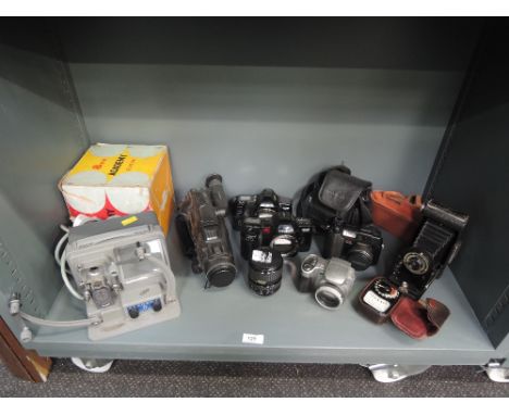 A selection of vintage cameras and photographic equipment including Minolta, Kodak etc