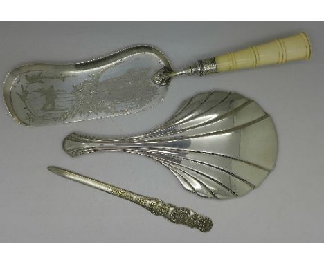 A plated crumb scoop with ivory handle, with farming scene engraved to the scoop, an Art Deco hand mirror and an Imperial Lif