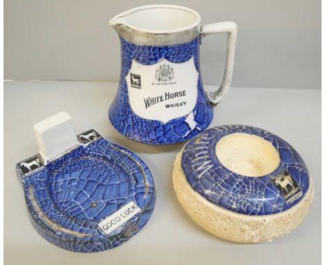 A collection of Shelley; White Horse whisky water jug, Good Luck ashtray and match striker