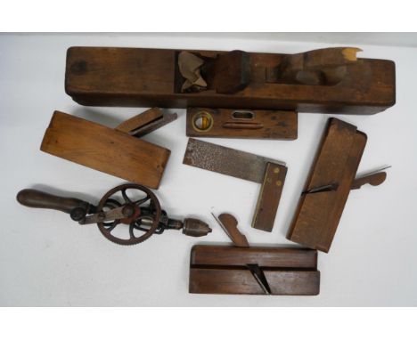 Four wooden planes, square, hand drill and spirit level  **PLEASE NOTE THIS LOT IS NOT ELIGIBLE FOR IN-HOUSE POSTING AND PACK