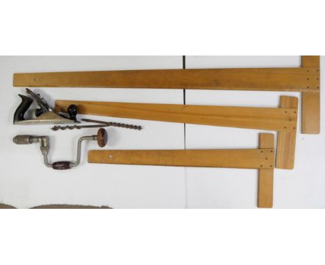 A collection of tools including draughtsman's T squares, Record No 4 wood plane and joiners brace with two bits