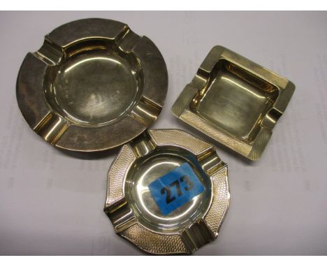 Three early 20th century silver ash trays, two with engine turned decoration, mixed marks