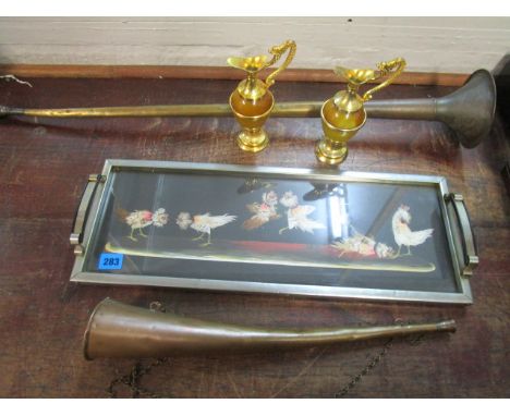 An early 20th century metal framed tray having twin handles and a central panel depicting a cock fighting scene made of feath