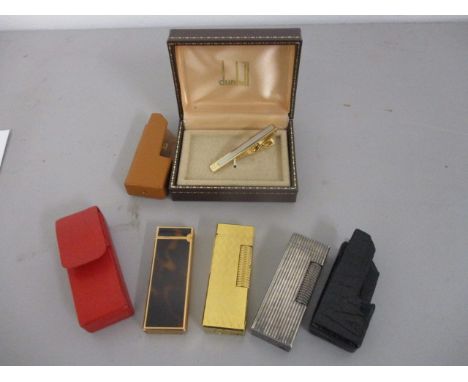 Three as new Dunhill cigarette lighters and a tie clip