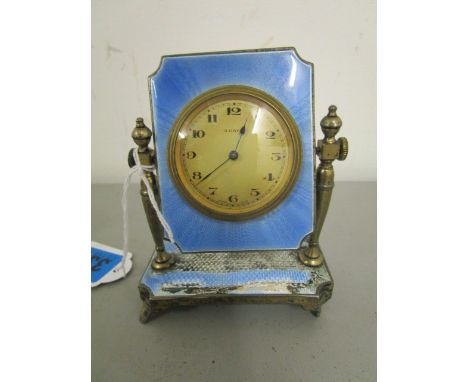 A 1920s silver and blue guilloche, enamelled dressing table 8 day clock on an adjustable stand A/F, London 1929, initials R C